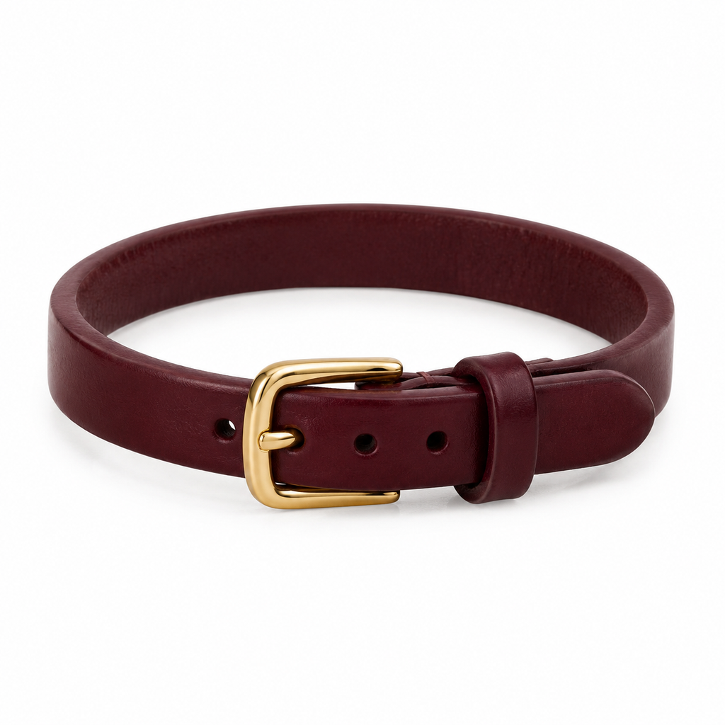 Burgundy leather bracelet with gold buckle, laid flat