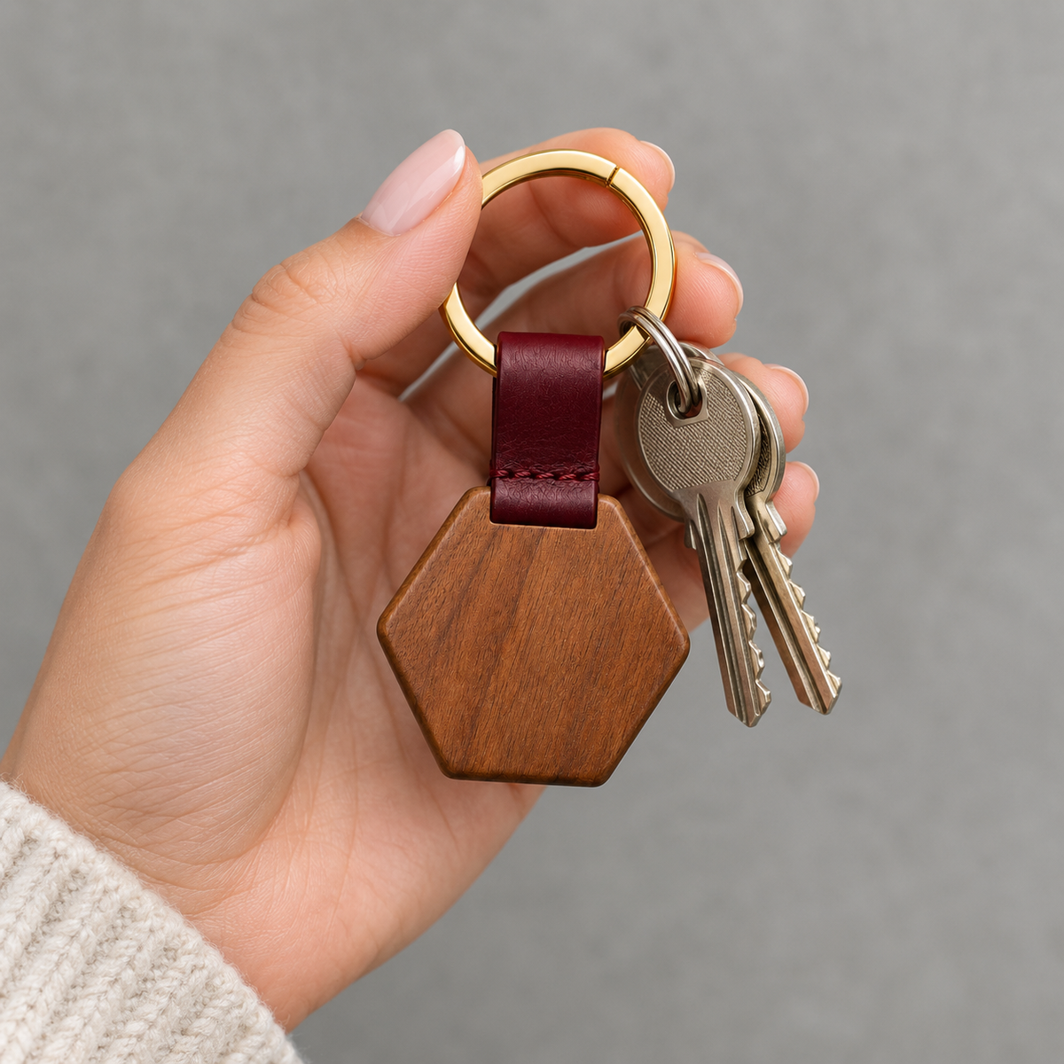 Close-up of wooden keychain with hexagonal shape.