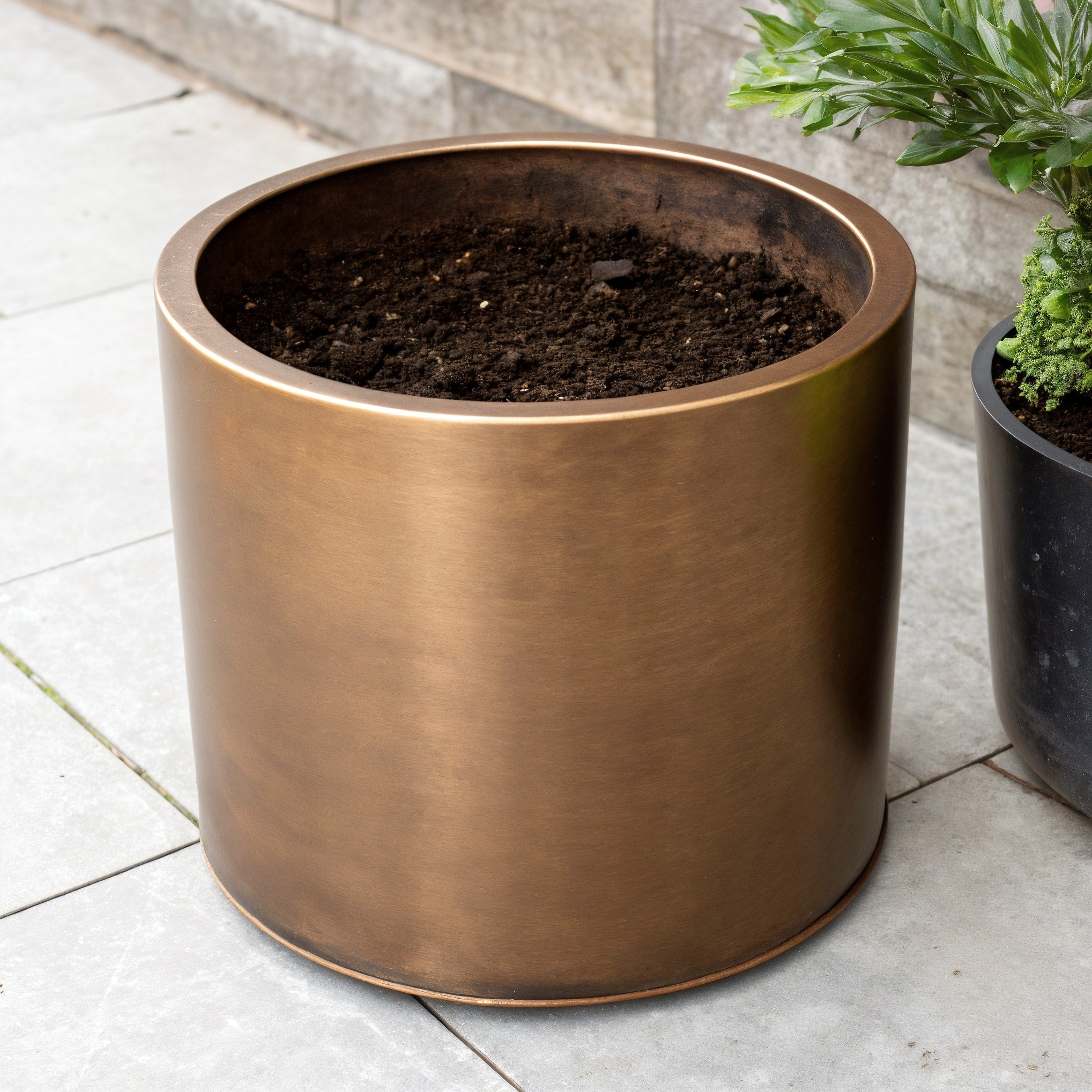 Vensioshop Bronze Metallic Ceramic Planter — three-quarter front view showing the full silhouette and metallic finish.