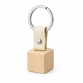 Front view of wooden keychain with leather strap and metal ring.