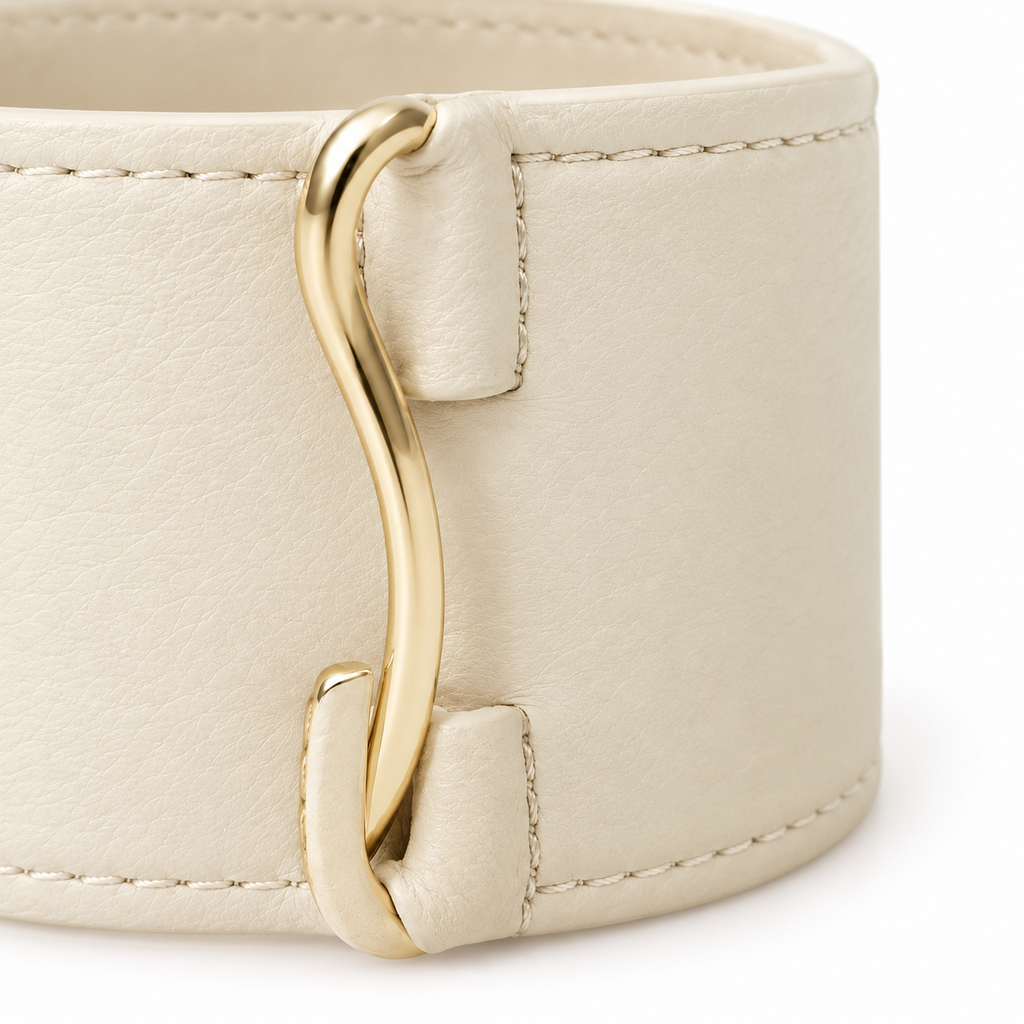Cream leather cuff bracelet displayed on a surface.