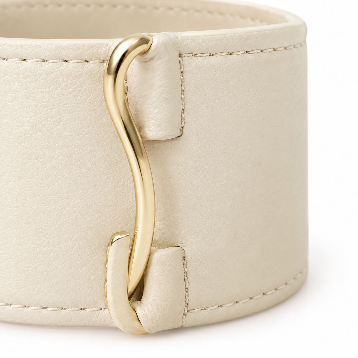 Cream leather cuff bracelet displayed on a surface.
