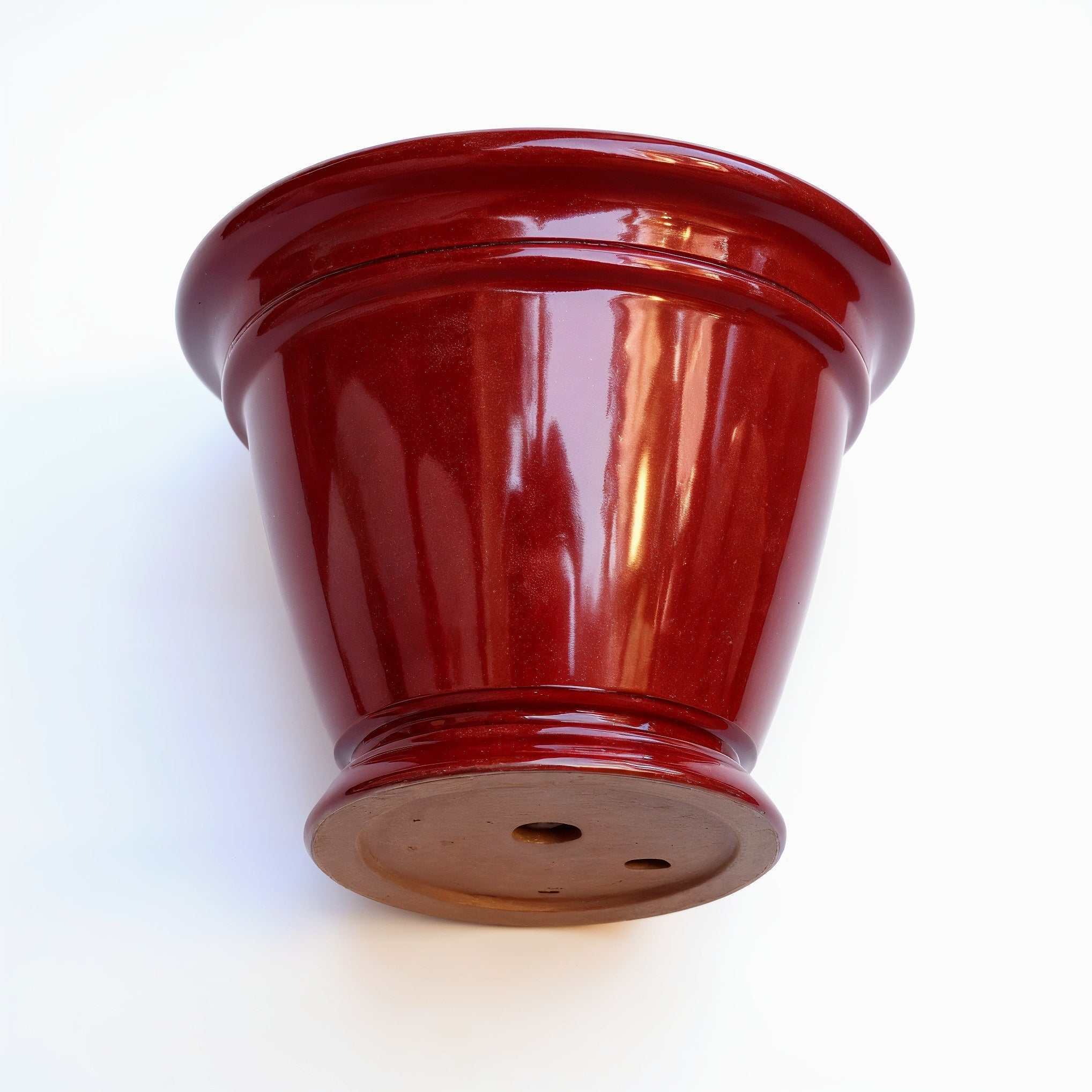 Vensioshop Ruby Red Ceramic Planter — Underside view displaying the base and drainage hole.