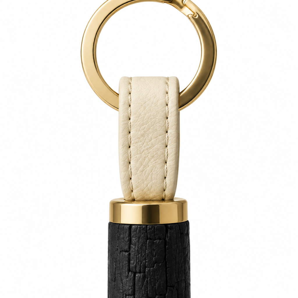 Charcoal keychain with elegant design and gold accents.