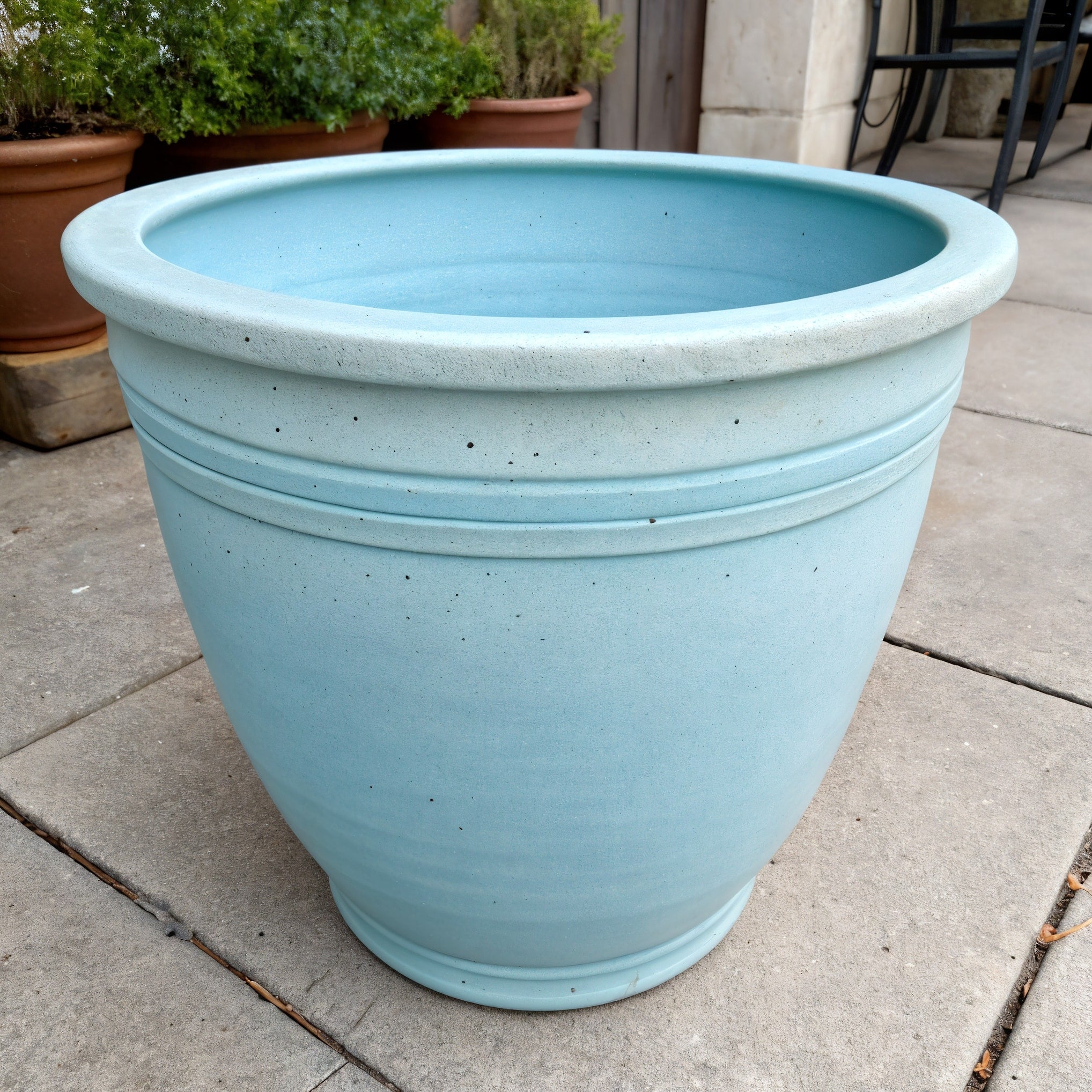 Vensioshop Pastel Blue Ceramic Planter — three-quarter front view showing the planter's wide bowl shape and matte finish