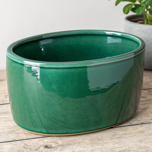 Vensioshop Emerald Green Oval Ceramic Planter — three-quarter front view showing the glossy emerald green finish